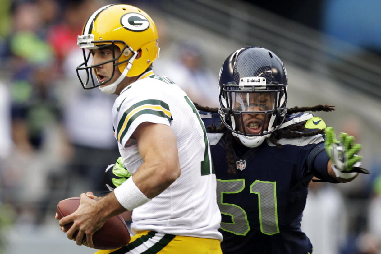 Green Bay Packers quarterback Aaron Rodgers, left, is sacked by Seattle Seahawks defensive end Bruce Irvin last season in Seattle.