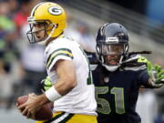 Green Bay Packers quarterback Aaron Rodgers, left, is sacked by Seattle Seahawks defensive end Bruce Irvin last season in Seattle.