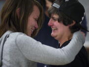 Ashley Cavner, 21, left, and Jessica Lee, 19, both of Vancouver, embrace after receiving their marriage license at the Clark County Auditor's Office today. The couple, who have been together for 18 months, arrived at 9 p.m.