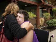 Dustina Haase-Lanier is comforted by family friend Julie Wimber, left, after her apartment caught fire at the Cascadia Village apartment complex this morning.