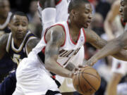 Mo Williams, left, attempts to guard Damian Lillard while playing for Utah last season.