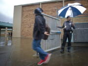 District Resource Officer Donald &quot;Raven&quot; Hubbard gets ready to lock an exterior gate as he makes sure children are headed to class at the start of the school day at McLoughlin Middle School on Feb. 14, 2012.