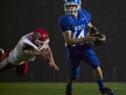 La Center quarterback Dylan King scrambles in the first half against Castle Rock at La Center Middle School on Friday.