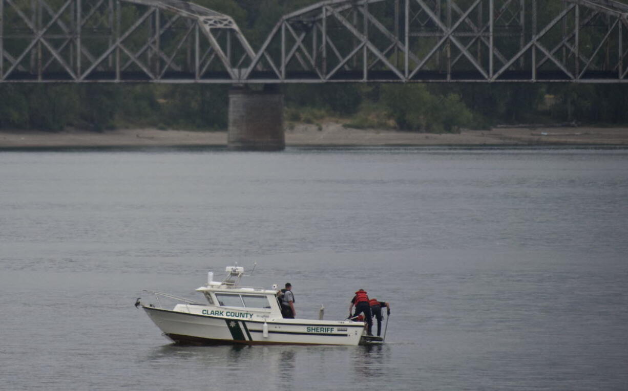 Clark County Sheriff's Office deputies recover a body from the Columbia River on Wednesday evening.