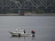 Clark County Sheriff's Office deputies recover a body from the Columbia River on Wednesday evening.