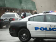 Vancouver Police officers confer outside Evergreen High School on Dec. 12 in Vancouver after a student was accused of bringing a gun to school and leaving it in a classroom.