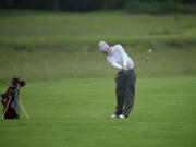 Brian Humphreys of Camas High School hits from the fairway on the fourth hole at Camas Meadows during the first round of the 4A state golf championship Tuesday.