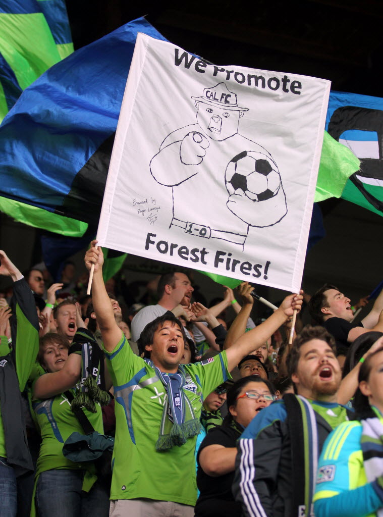 Seattle Sounders fans cheer before the start of Sunday's MLS soccer game between the Sounders and the Portland Timbers at Jeld-Wen Field.