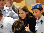 Amanda Knox cries following the verdict that overturns her conviction and acquits her of murdering her British roommate Meredith Kercher, at the Perugia court.