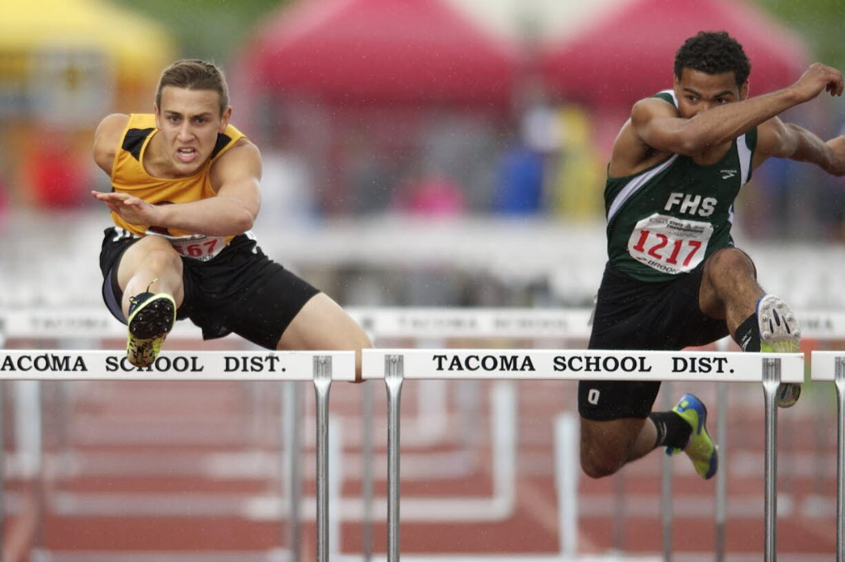 Prairie's Peter Zalk, left, clears the final hurdle in the boys 3A 110 high hurdles at the WIAA State Track &amp; Field meet Friday at Mount Tahoma High School in Tacoma.