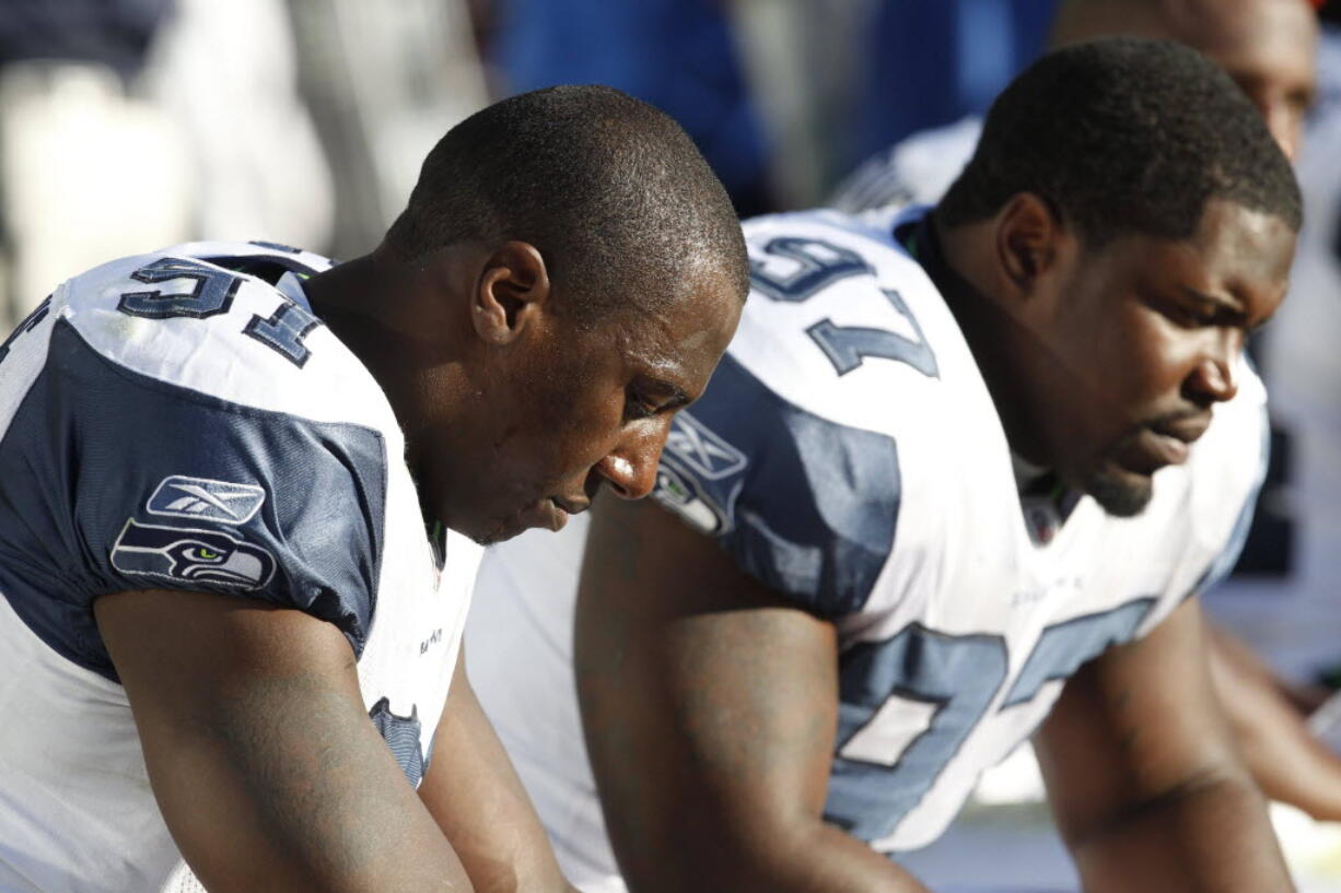 Seattle Seahawks defensive end Chris Clemons, left, will return to the practice field on Wednesday, his first football action since suffering a knee injury against Washington last season.