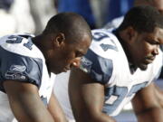 Seattle Seahawks defensive end Chris Clemons, left, will return to the practice field on Wednesday, his first football action since suffering a knee injury against Washington last season.