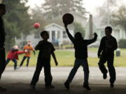 Kids in the Vancouver-Clark Parks and Recreation's Kids First After School program play wall ball at the Washington Elementary School playground in January.