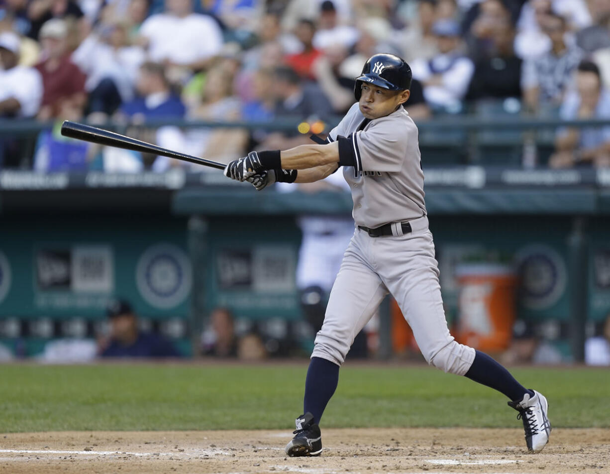 New York Yankees' Ichiro Suzuki swings on an RBI single in the third inning of a baseball game against the Seattle Mariners, Thursday, June 6, 2013, in Seattle. (AP Photo/Ted S.