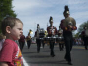 Alexander Voukidis, 23 months, watches the Moses Lake High School band pass at the 48th annual Hazel Dell Parade of Bands.