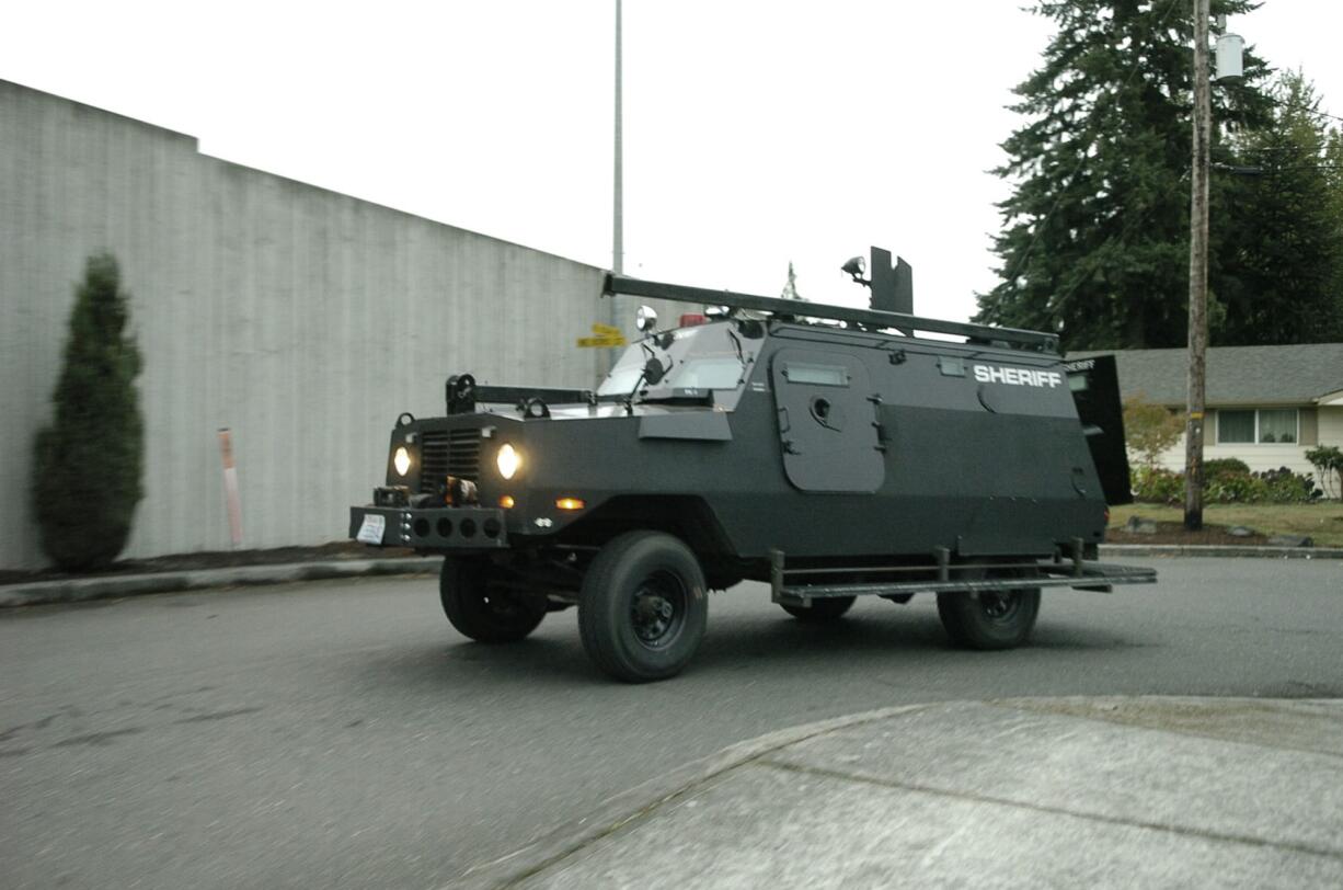 SWAT officers respond to a Hazel Dell home Wednesday morning in an armored vehicle. Officers served a search warrant in connection to evidence linked to an Oct.