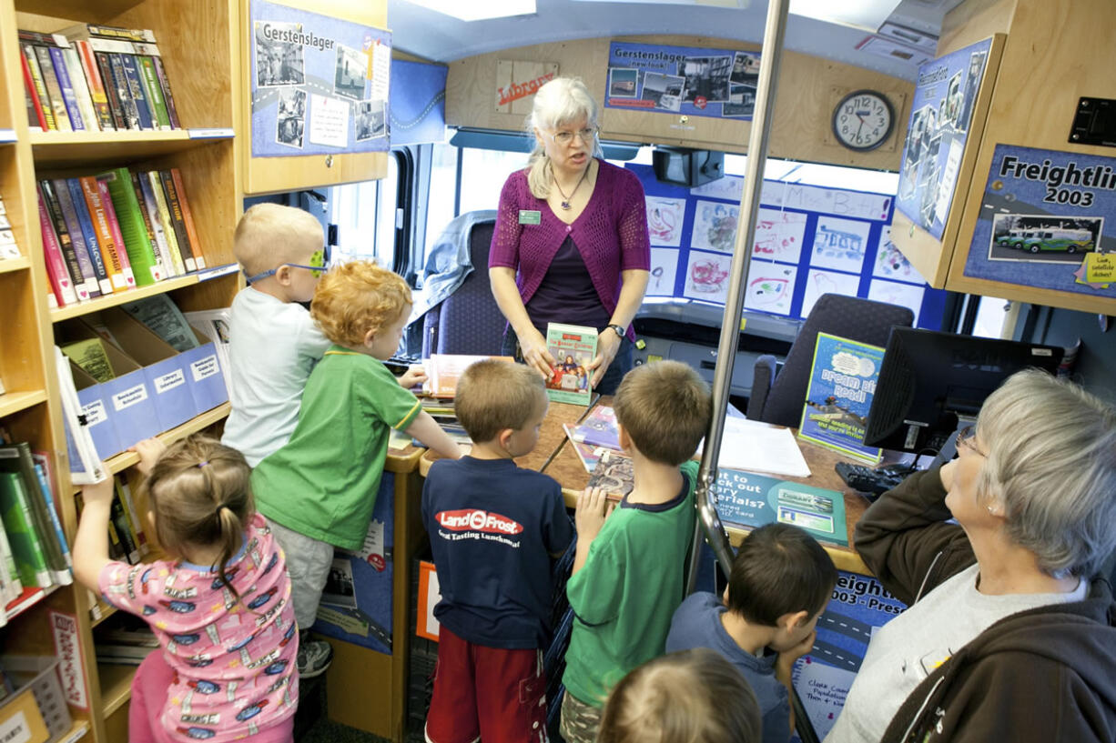 Preschoolers from Country Friends Daycare gather around Beth Townsend, Senior Library Assistant, to say goodbye while the bookmobile makes its final stop Friday morning at Hockinson.