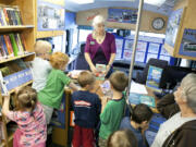 Preschoolers from Country Friends Daycare gather around Beth Townsend, Senior Library Assistant, to say goodbye while the bookmobile makes its final stop Friday morning at Hockinson.