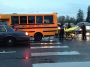 A 15-year-old girl was sent to the hospital after being hit by a school bus in Battle Ground Tuesday morning, officials said.