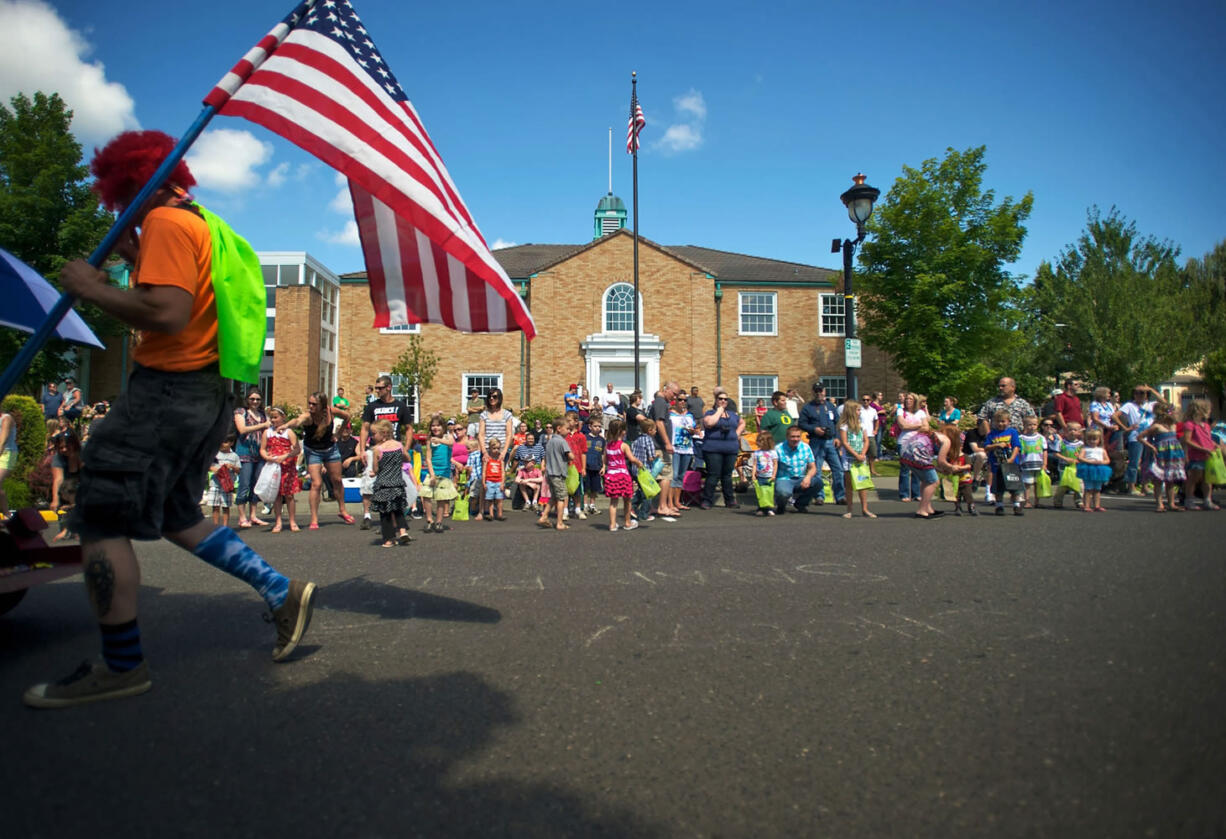 The Camas Days Grand Parade marches past the Public Library in 2012.