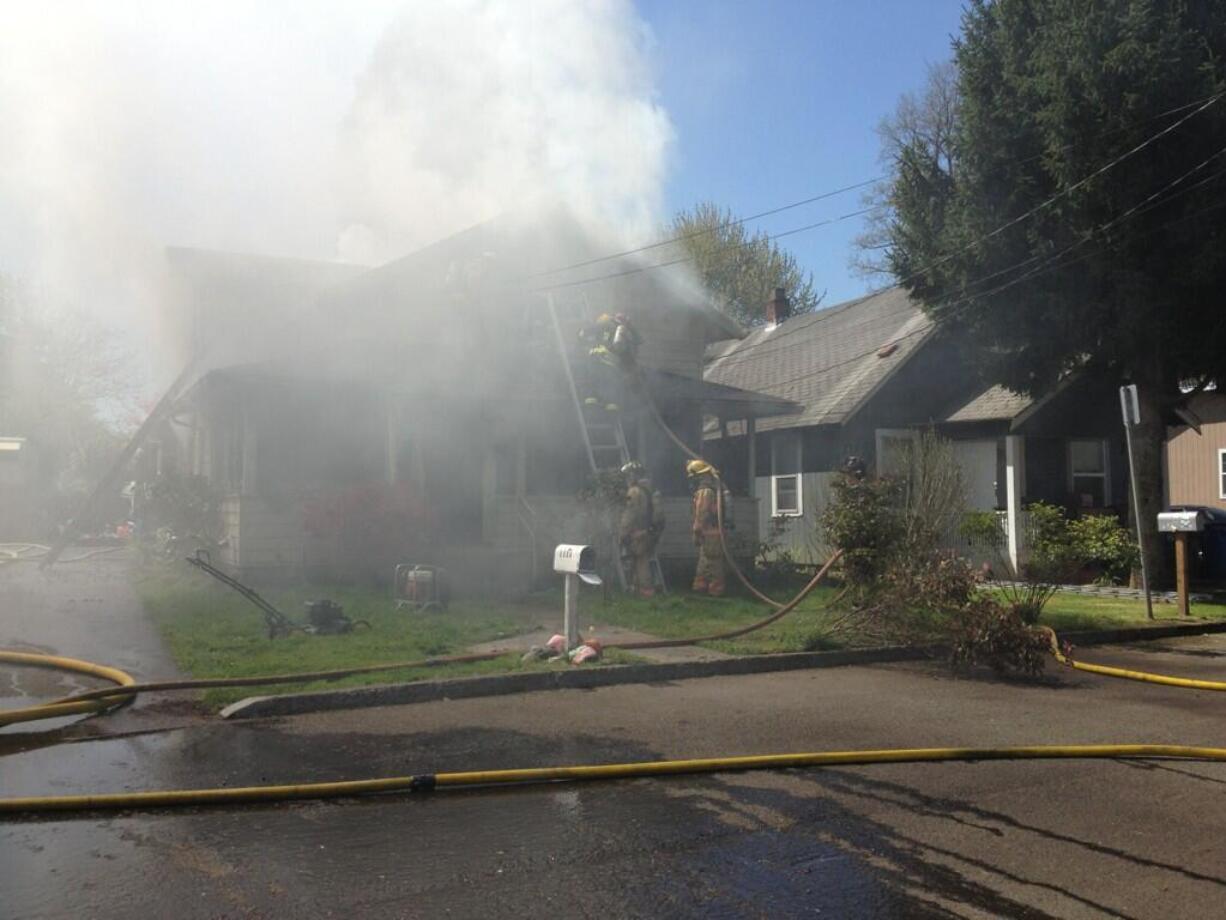 Firefighters battle a blaze at 1524 S.E. Seventh Ave.