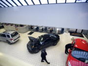 Sales personnel at Vancouver Ford wait to assist customers inside the showroom in January.