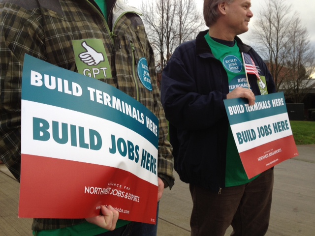 BNSF employee Tim Falsetto, right, joins pro-coal activists Wednesday in advance of a public hearing at Clark College on a proposed coal export facility near Bellingham.