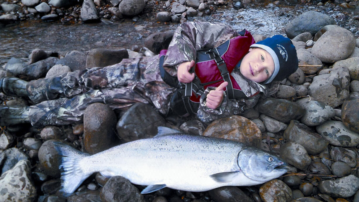 Ty Bodenhamer of Chehalis stretches out to show the length of a spring chinook he caught in 2014 on the Cowlitz River.