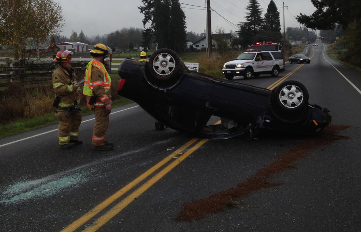 A rolled car blocked Northeast 10th Avenue in Ridgefield for about 20 minutes Tuesday morning.