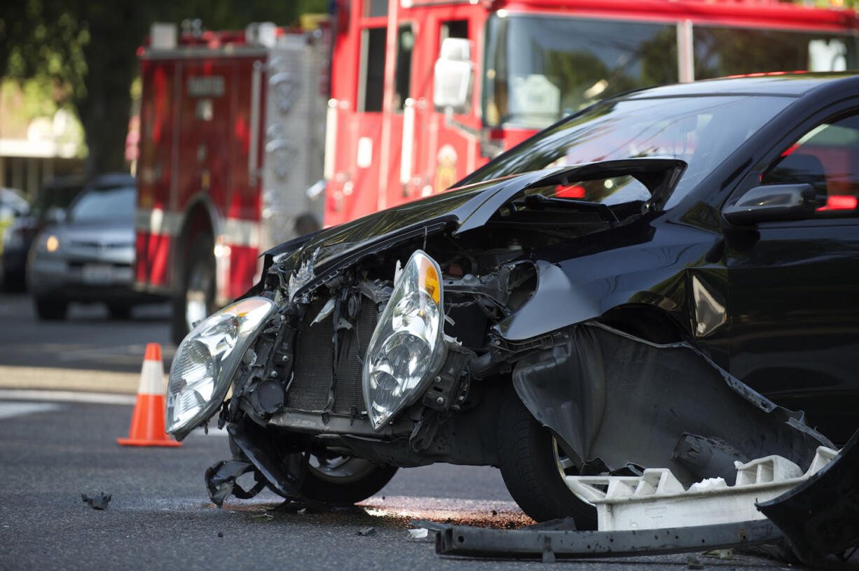 Firefighters respond to a minor injury car accident at the intersection of East Mill Plain Boulevard and Broadway Street Monday.