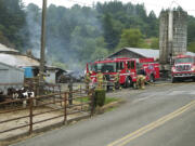 Firefighters returned to Stauffer's Dairy Farm near Washougal on Monday morning after an overnight fire rekindled.