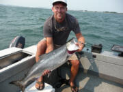 Doug Borneman of Bellingham poses with a chinook he caught in the Columbia River estuary in August.