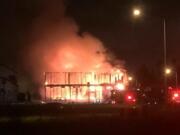 Fire engulfs a building Tuesday night that was under construction in east Vancouver.