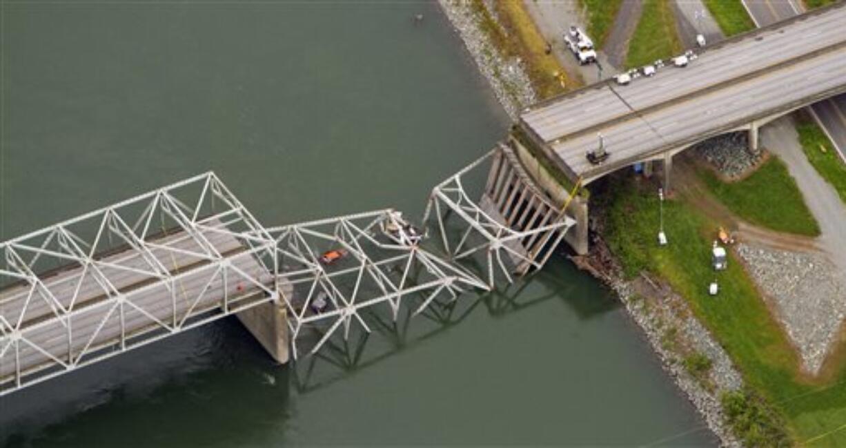 A collapsed section of the Interstate 5 bridge over the Skagit River is seen in an aerial view Friday, May 24, 2013. Part of the bridge collapsed Thursday evening, sending cars and people into the water when a an oversized truck hit the span, the Washington State Patrol chief said. Three people were rescued from the water. Washington Gov.