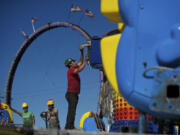 Workers assemble carnival rides Aug.