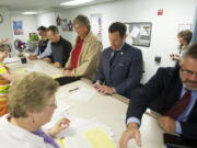 Ron Onslow, from left, Donald Stose, Dean Bloemke, Tim Leavitt and Sean Guard file paperwork at the Clark County Elections Office on Monday morning to become candidates in the upcoming election.