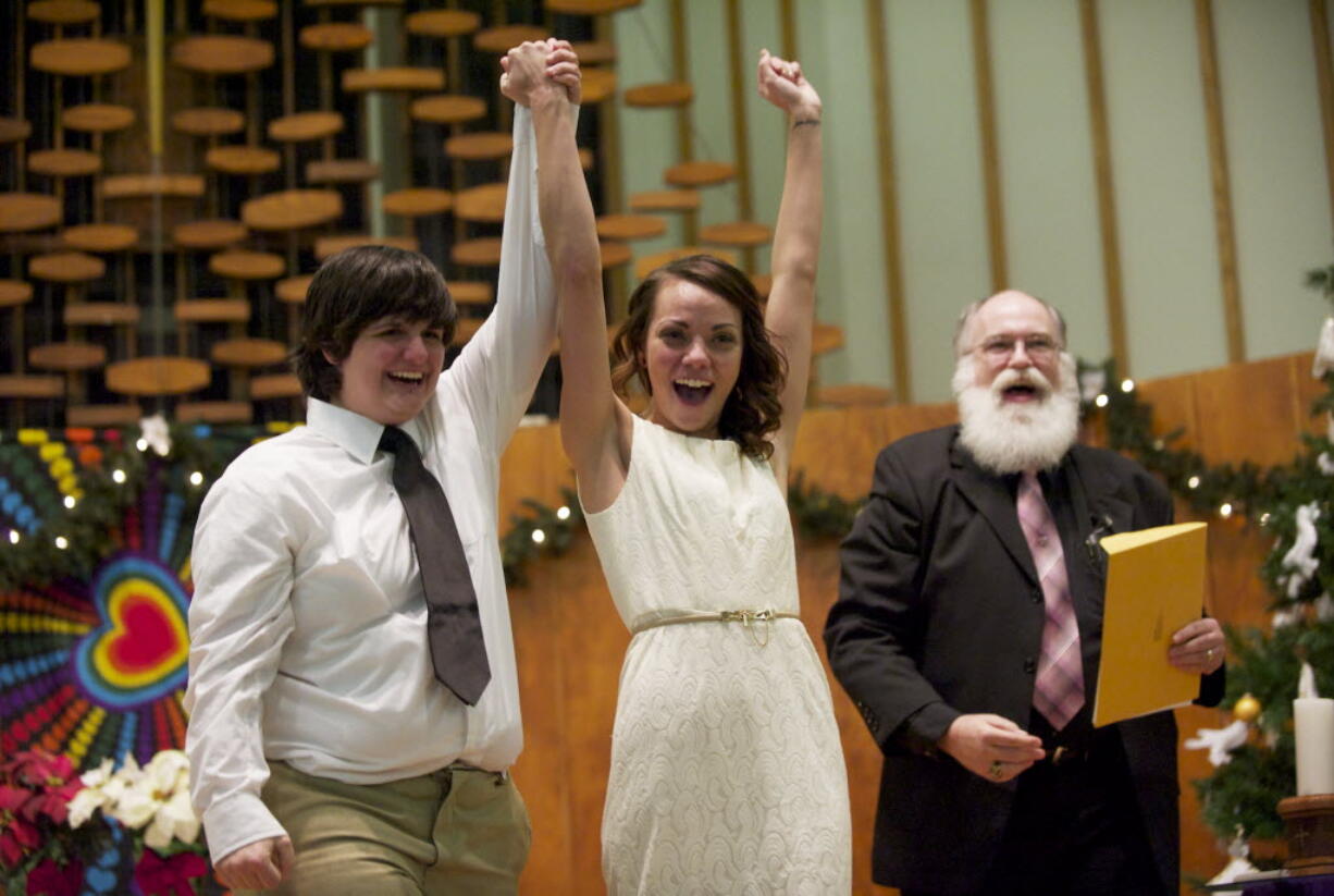 Ashley Cavner, 21, and Jessica Lee, 19, were the first gay couple to marry just after midnight at a mass wedding at Vancouver's First Congregational United Church of Christ.