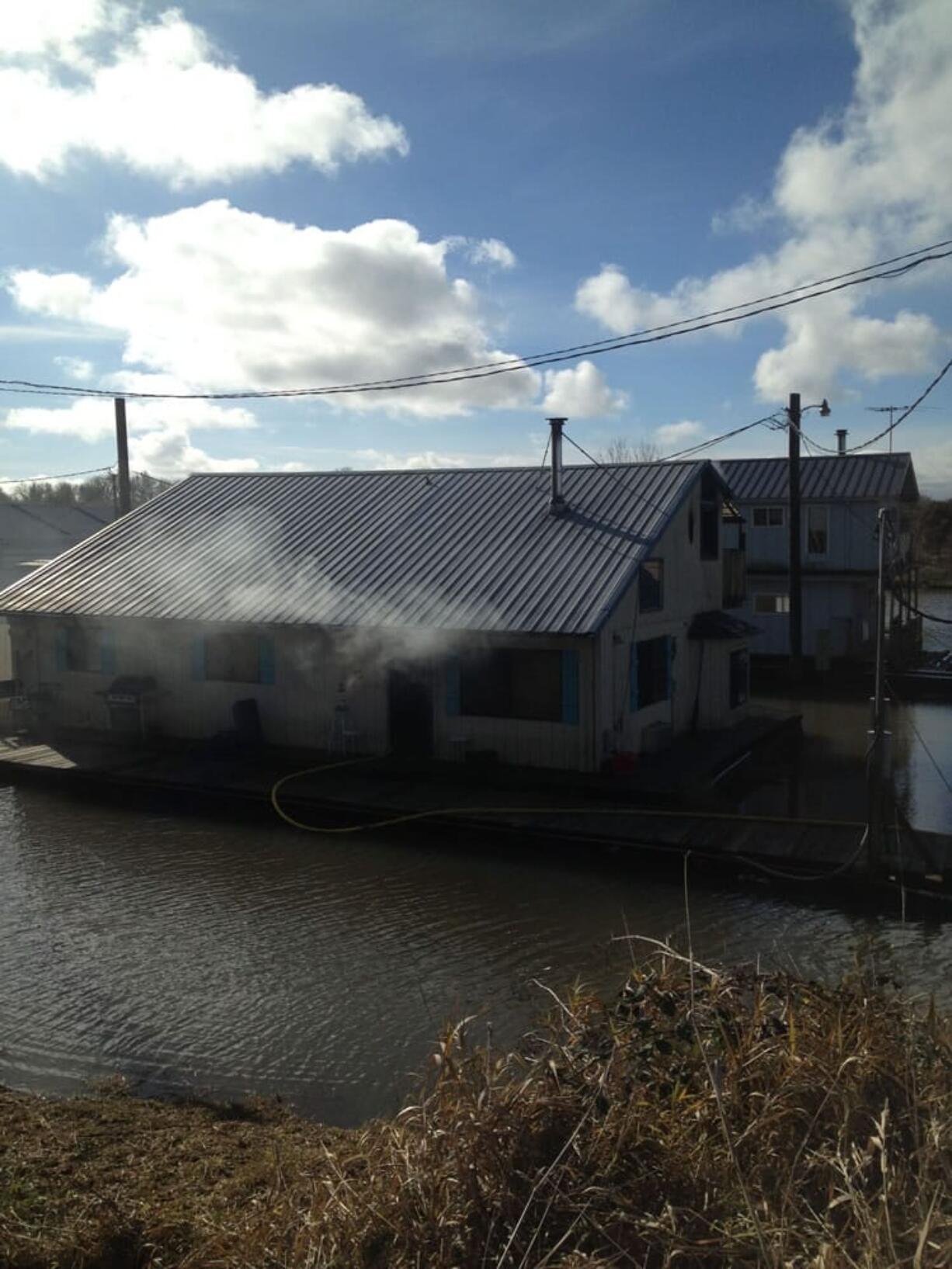 Firefighters contained a fire at a floating residence in Ridgefield Friday morning.