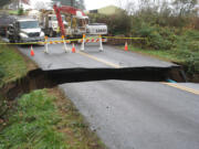 A washout cuts a gash through Northeast Charity Road in La Center early Saturday.