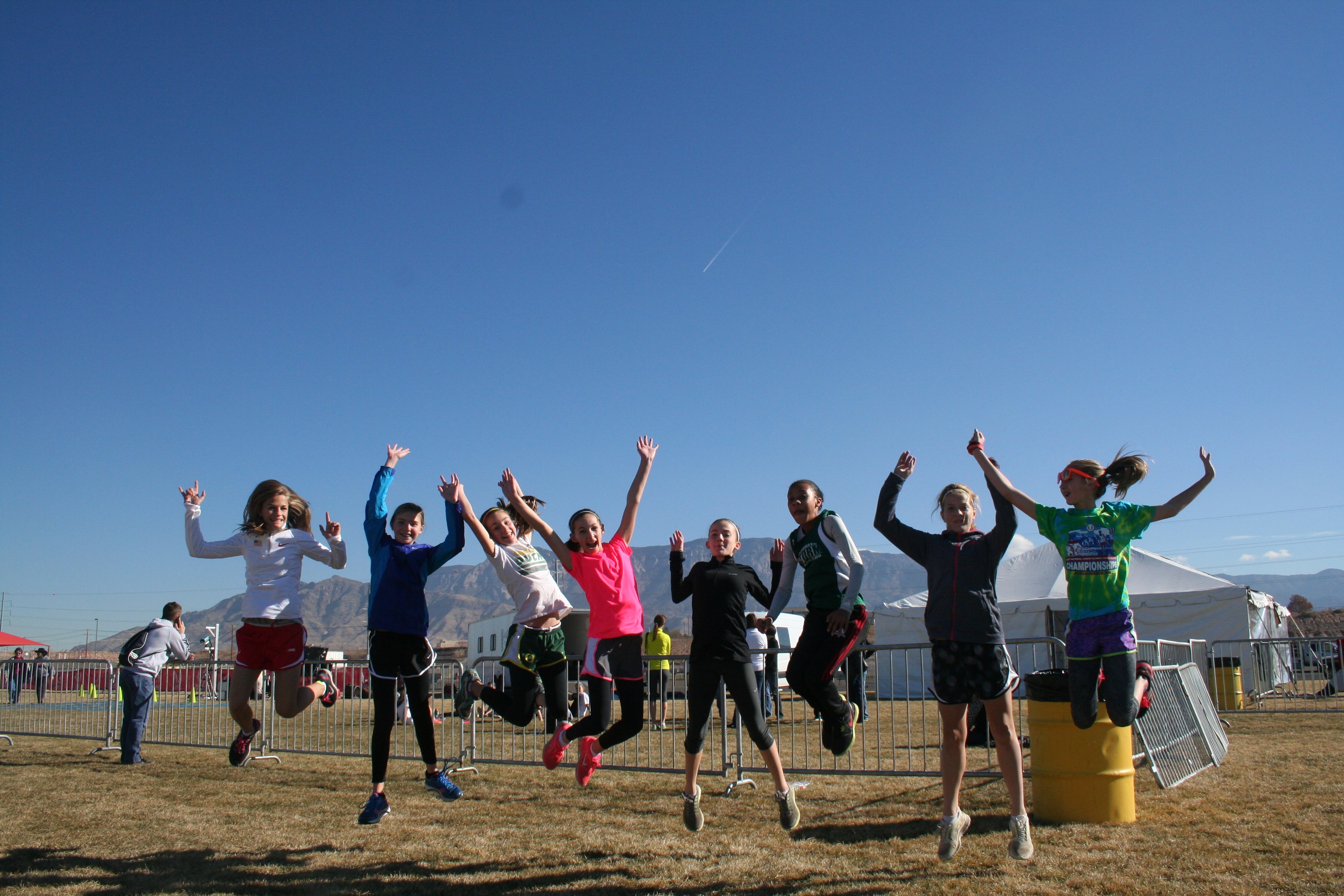 Members of the Evergreen Storm -- Emily Wilson, Paige Neff, Kaylee Merritt, Carla Jooste, Ashlin O'Neill, Serena Smith, Callie Rheaume and Jenna Efraimson -- show their enthusiasm before the Junior Olympics Cross Country championships.