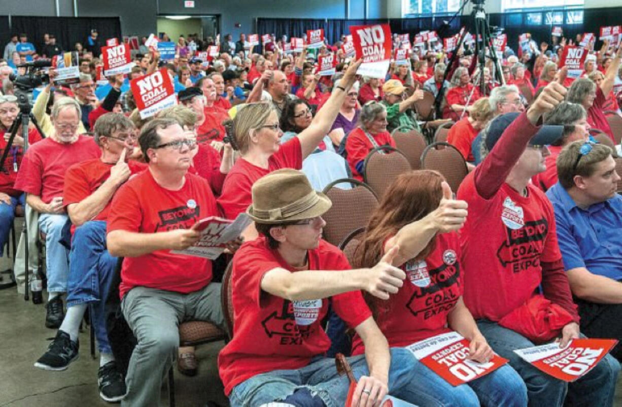 Opponents of Millennium Bulk Terminal's plan to build a coal terminal in Longview respond to a statement during an evening hearing at the Cowlitz Expo Center in Longview.