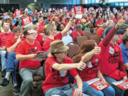 Opponents of Millennium Bulk Terminal's plan to build a coal terminal in Longview respond to a statement during an evening hearing at the Cowlitz Expo Center in Longview.