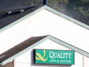 A man stands atop a smoldering hotel in Hazel Dell on Saturday.