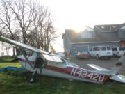 A Cessna 150 sits near the Brush Prairie home of Mark and Angela Congdon, where it crashed while trying to land at Brush Prairie Aerodrome about 5:15 p.m.