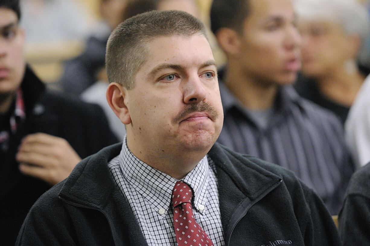 Portland police Officer James Botaitis waits in court Friday for his arraignment on charges of second-degree assault with a deadly weapon, first-degree burglary and harassment.