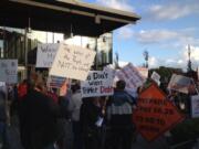 Protesters gathered outside of Vancouver Community Library as part of a rally dubbed &quot;Unite Against Tyranny&quot; against C-Tran in connection with the agency's decision to approve a contract with TriMet to operate light rail in Clark County