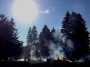 Firefighters mop up hot spots after a two-alarm brush fire broke out near the intersection of Northeast 49th Street and 137th Avenue.