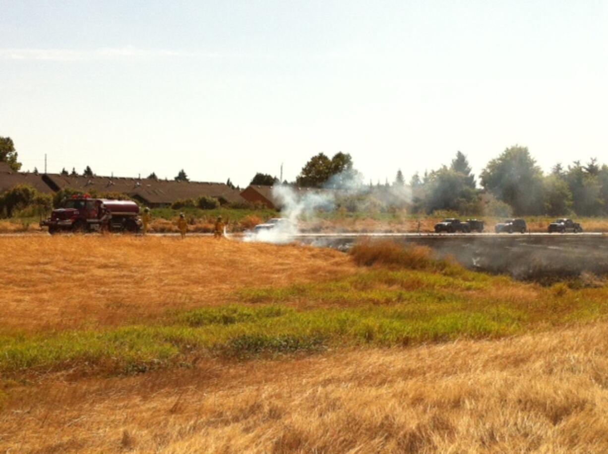 Firefighters on Friday morning knocked out a grass fire on Interstate 205 near state Highway 500.