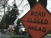 Clark Public Utilities crews work to repair a power line damaged by a tree near 28th and Main streets in west Vancouver early Monday.