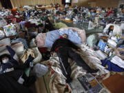 FILES/Associated Press
An evacuee sleeps on a blanket at a shelter in Rikuzentakata, Iwate Prefecture, after the 2011 magnitude 9.0 earthquake and tsunami in Japan. A similar earthquake in the Pacific Northwest caused by the Cascadia fault could pack shelters for months and destroy the regional economy.